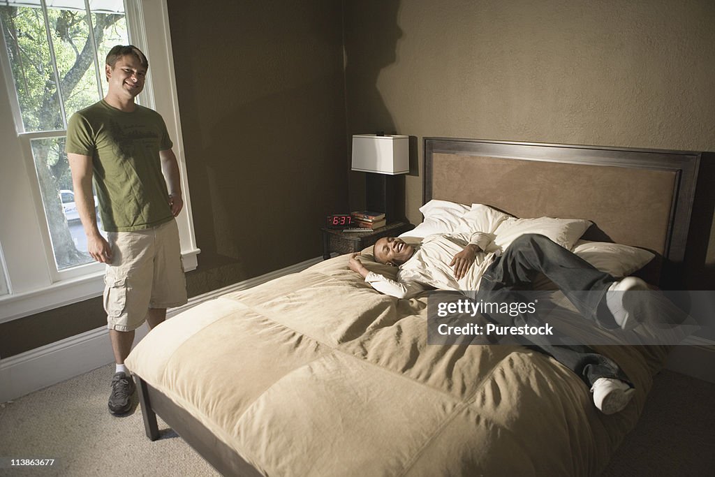 Portrait of two young men in a bedroom