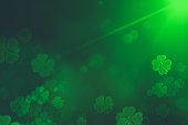 St. Patrick's Day green Shamrock Leaves background. Patrick's Day backdrop with growing clover leaf extreme close-up. Patrick Day pub party background