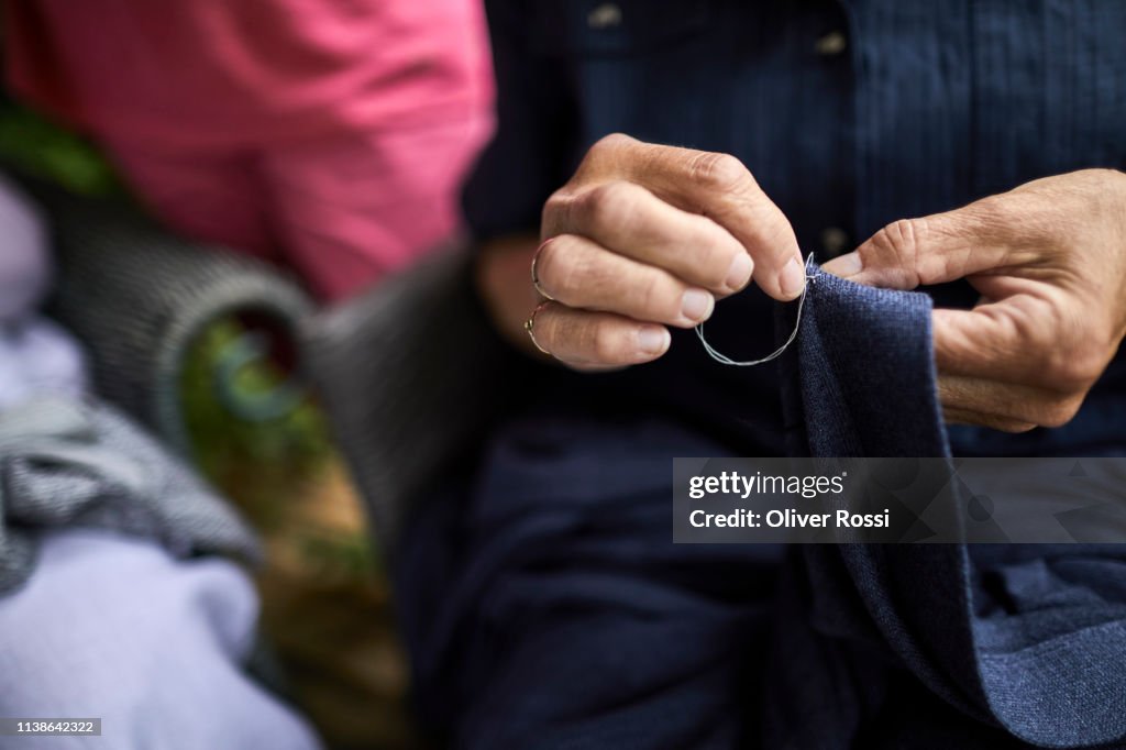 Close-up of senior woman sewing