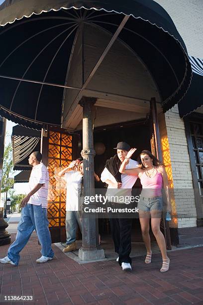 young men and women leaving a bar at sunrise - leaving restaurant stock pictures, royalty-free photos & images