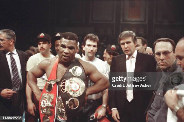 Businessman Donald Trump in ring with boxer Mike Tyson after knocking out opponent Larry Holmes at Tyson vs Holmes Convention Hall in Atlantic City,...