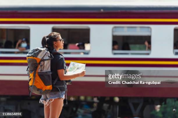 asian woman backpacker watching map travel train thailand - students map imagens e fotografias de stock