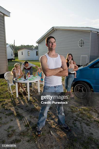 portrait a man with his family and friends in front of trailer homes - トレーラハウス ストックフォトと画像