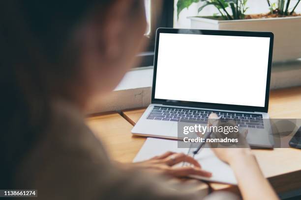 woman hands working with blank screen laptop computer mock up.hands at work with digital technology.working on desk environment.planing and working with mobile device screen template. - laptop ストックフォトと画像