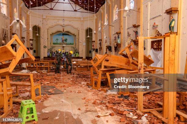 Sri Lankan soldiers inspect the damage inside St. Sebastian's Church where a bomb blast took place in Negombo, Sri Lanka, on Monday, April 22, 2019....