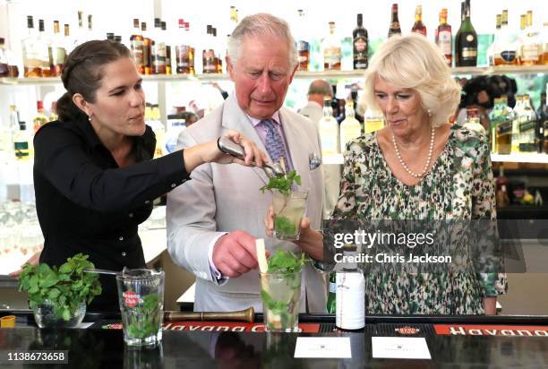 Prince Charles, Prince of Wales and Camilla, Duchess of Cornwall are shown how to prepare a mojito by Diana Figueroa as they visit a paladar called...