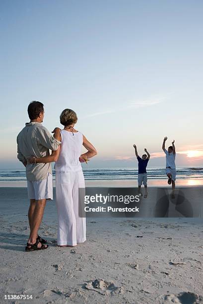 family vacation at the beach - mom flirting stock pictures, royalty-free photos & images
