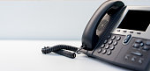 close up telephone VOIP technology standing on office desk in office room for network operation center job concept