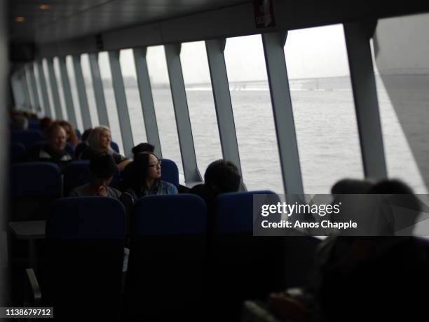 passengers on a ferry. - amos chapple stock pictures, royalty-free photos & images