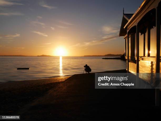 a photographer watches the sun rise - amos chapple stock pictures, royalty-free photos & images