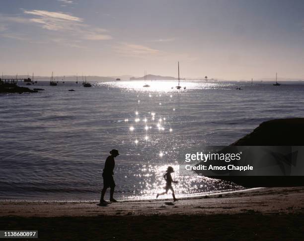 a child running in sparkling light. - amos chapple stock pictures, royalty-free photos & images