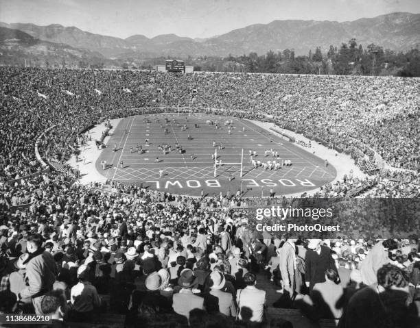 Elevated view of football fans crowded into the Rose Bowl Stadium to watch a game between the California Golden Bears and the Michigan Wolverines,...