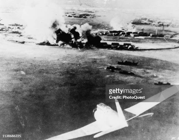 Aerial photograph of a surprise aerial strike against the United States naval base, Pearl Harbor, Hawaii, December 7, 1941. A Japanese bomber is...