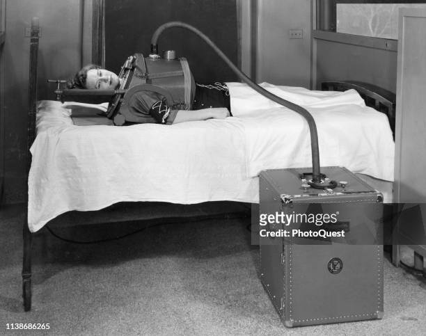 View of a woman in a 'Chestpirator,' a portable iron lung, Boston, Massachusetts, 1949. It was designed for use in a hospital for or in transporting...