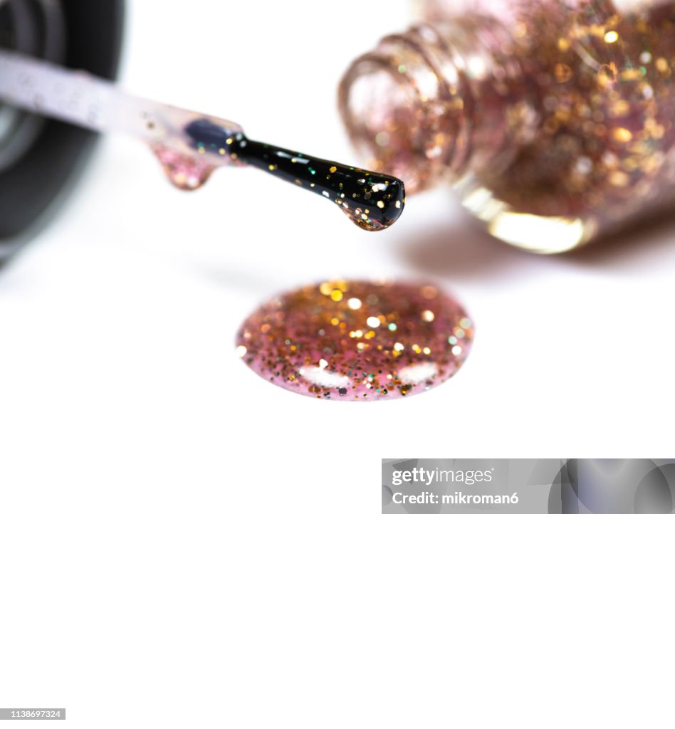 Nail varnish spilling onto white background. Abstract Background