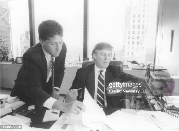 Real estate developer Donald Trump looks at his watch while working with Joseph Tahl, a real estate attorney in his office at Trump Plaza in New York...