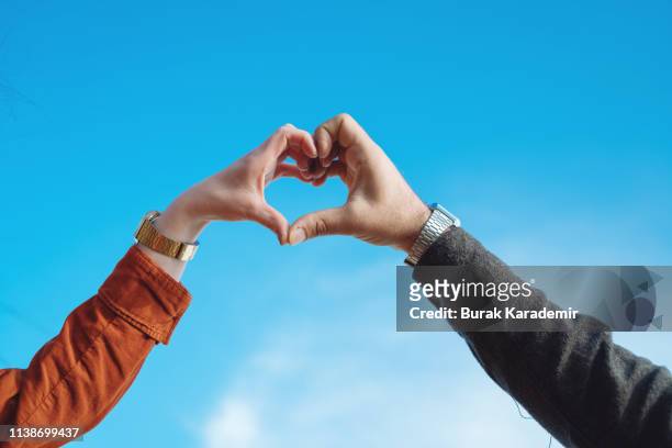 heart shape from couple hands - hand in heart shape stock pictures, royalty-free photos & images