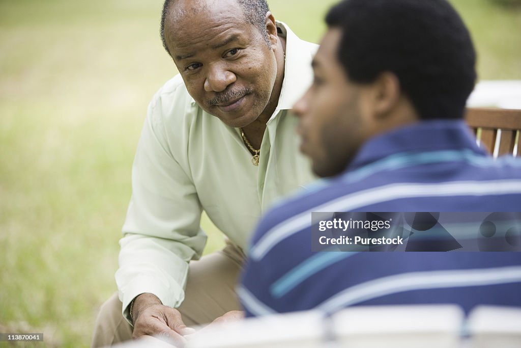 Close-up of a mature man talking to adult son