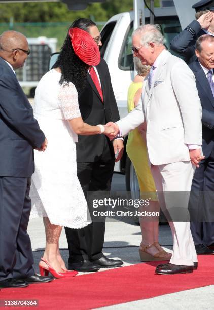 Prince Charles, Prince of Wales is greeted by dignitaries as he and and Camilla, Duchess of Cornwall arrive at Owen Roberts International Airport on...