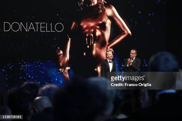 Roberto Benigni and Carlo Conti on the stage during the 64. David Di Donatello Award Ceremony on March 27, 2019 in Rome, Italy.