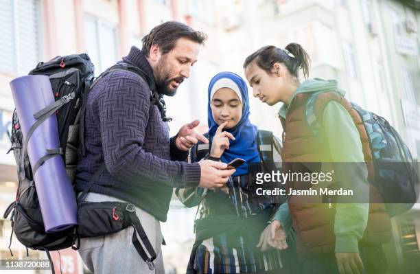 father and kids with backpacks on city street - antalya city stockfoto's en -beelden
