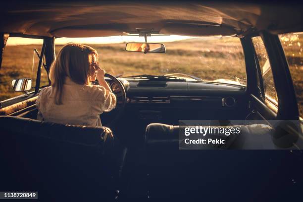 woman on road trip - old car interior stock pictures, royalty-free photos & images