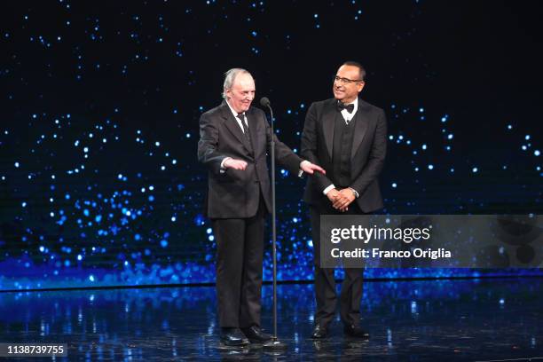 Dario Argento and Carlo Conti on the stage during the 64. David Di Donatello Award Ceremony on March 27, 2019 in Rome, Italy.