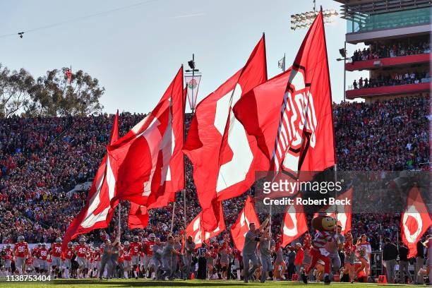 Rose Bowl: Ohio State mascot Brutus Buckeye taking field with cheerleaders carrying flags before game vs Washington at Rose Bowl. Pasadena, CA...