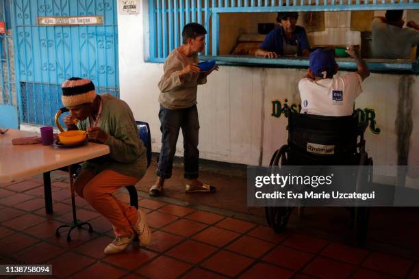 Woman eats soup at the nursery home "Casa Hogar Madre Teresa de Calcuta" in Mamera neighborhood on April 11, 2019 in Caracas, Venezuela. This nursery...