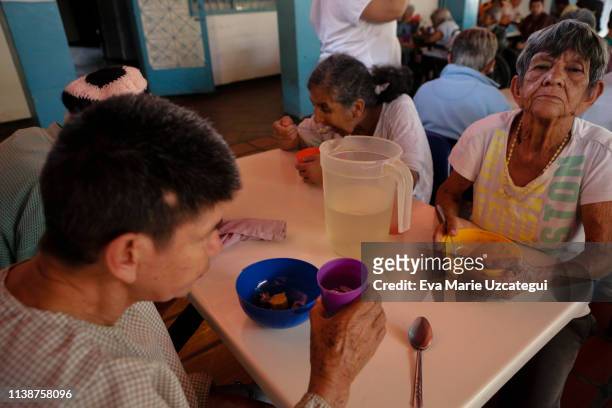 Women eat soup at the nursery home "Casa Hogar Madre Teresa de Calcuta" in Mamera neighborhood on April 11, 2019 in Caracas, Venezuela. This nursery...
