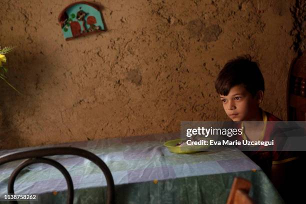 Luis, 12 years old, has lunch at his house in La Bombilla slum on April 18, 2019 in Caracas, Venezuela. Luis is the youngest son of Yunni, who works...