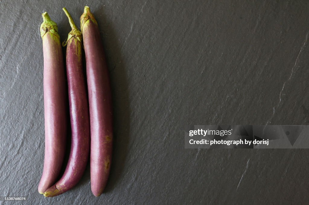 Japanese Eggplant or Brinjal on dark grey slate background