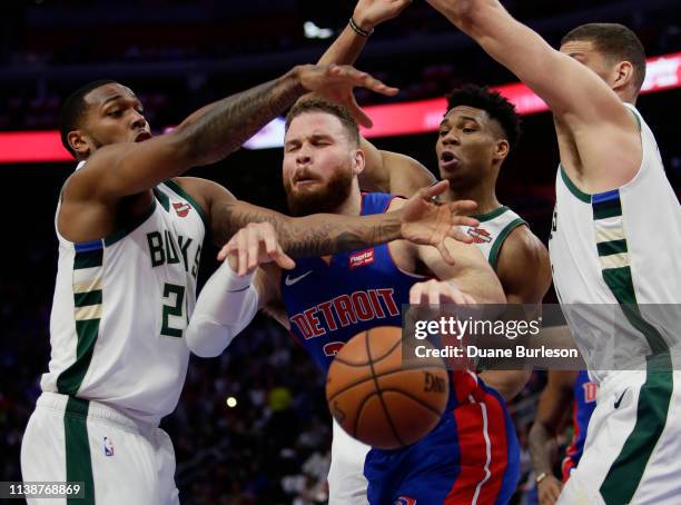 Blake Griffin of the Detroit Pistons is defended by Sterling Brown, Giannis Antetokounmpo and Brook Lopez of the Milwaukee Bucks while going to the...