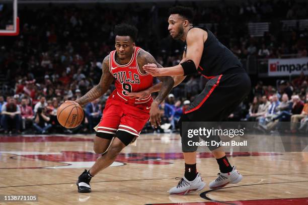 Antonio Blakeney of the Chicago Bulls dribbles the ball while being guarded by Evan Turner of the Portland Trail Blazers in the second quarter at the...