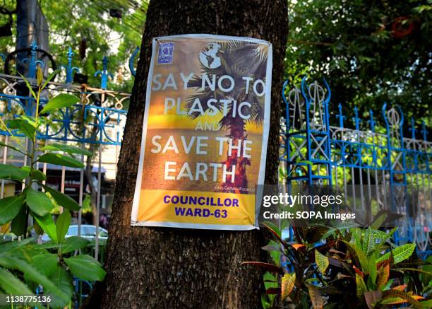 Placard that says Say No to Plastic and Save the Earth seen hanging on a Tree at the Allen Park during the World Earth Day celebration. An NGO named...