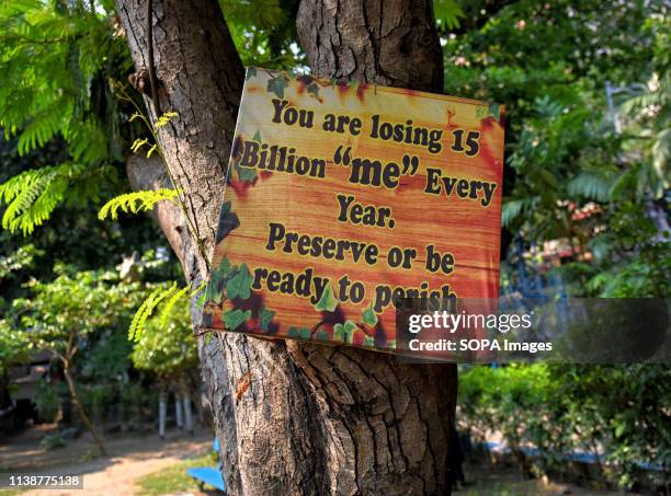 Placard that says 'you are losing 15 billion me every year, preserve or be ready to perish' seen hanging on a Tree at the Allen Park during the World...