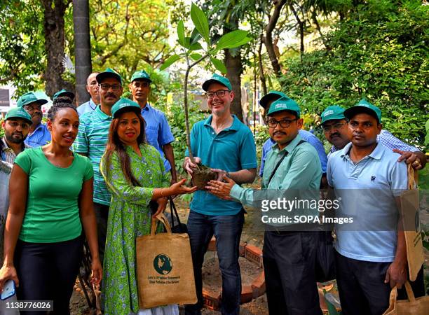 NGOs from Rakshak Foundation in association with the Greening Team of the United states are seen holding a tree to be planted during the during the...