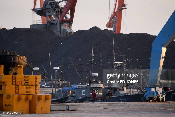 This photo taken on November 20, 2017 shows ships and coal at Rajin harbour in North Korea's northeastern city of Rason, near the borders of both...