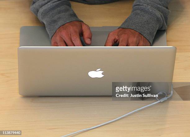 Customer types on a MacBook laptop at an Apple Store following an announcement that Apple has become the world's most valuable brand on May 9, 2011...