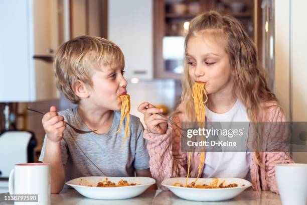 eating spaghetti with bolognese sauce - the joys of eating spaghetti stock pictures, royalty-free photos & images