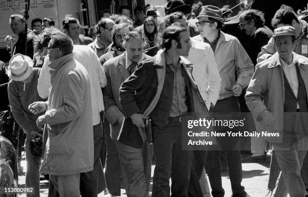 Making of movie The Godfather on Mott Street in Manhattan. Simulated blood dripping from his mouth, Marlon Brando is surrounded by movie people after...