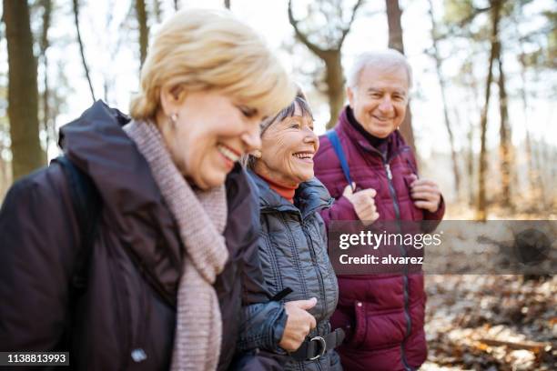 active seniors on country walk - winter walk stock pictures, royalty-free photos & images