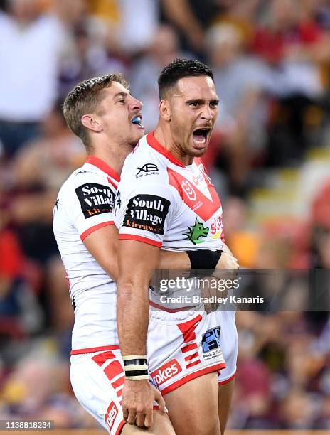 Corey Norman of the Dragons is congratulated by team mates after kicking the winning field goal during the round 3 NRL match between the Brisbane...