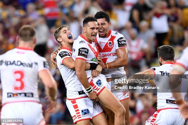 Corey Norman of the Dragons is congratulated by team mates after kicking the winning field goal during the round 3 NRL match between the Brisbane...