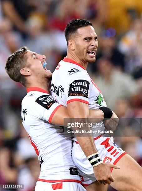 Corey Norman of the Dragons is congratulated by team mates after kicking the winning field goal during the round 3 NRL match between the Brisbane...