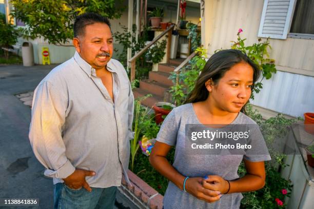 a mexican family residing in the usa in front of their home in san bernardino county in southern california - migrant worker stock pictures, royalty-free photos & images