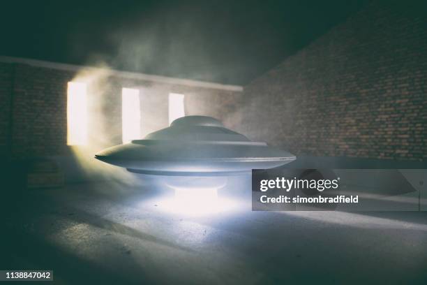 flying saucer in the garage - ufo saucer stock pictures, royalty-free photos & images