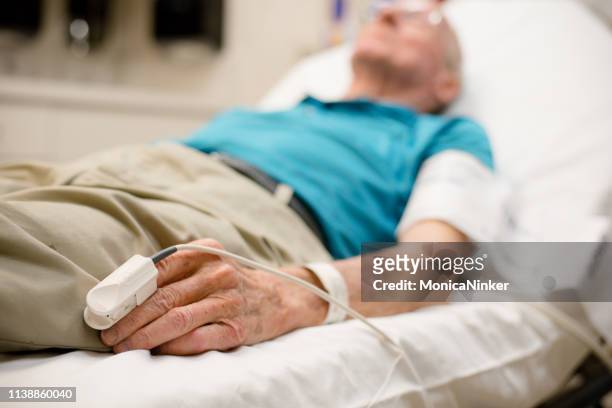 a visit to the er - adult male hospital bed stock pictures, royalty-free photos & images