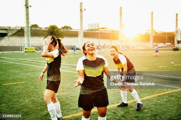 laughing female soccer players warming up on field before game - comic strip bildbanksfoton och bilder