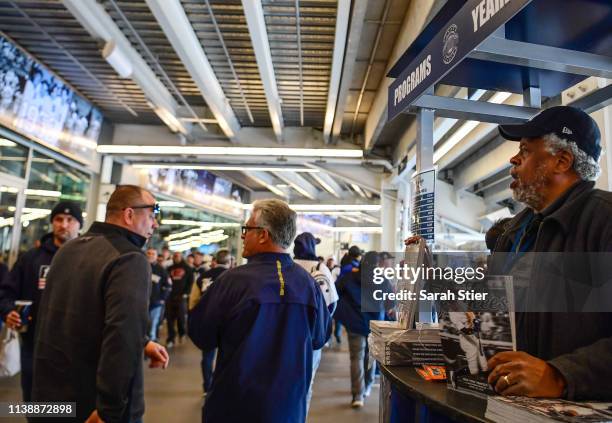 An employee sells programs before the game between the New York Yankees and the Baltimore Orioles on Opening Day at Yankee Stadium on March 28, 2019...